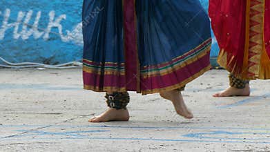 Woman dancing indian dance with bells on her legs