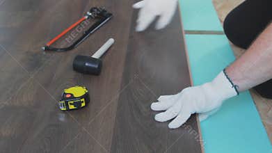 Man install laminate flooring on apartment