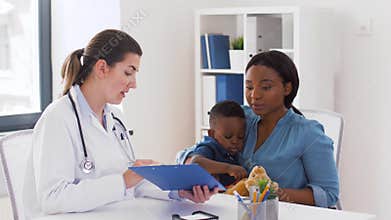 Mother with baby son and doctor at clinic