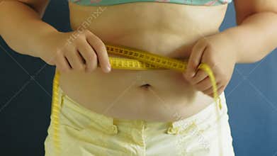 Fat woman belly closeup on blue background