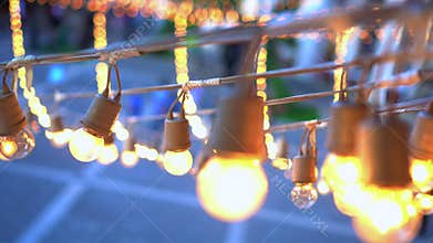Festival light bulbs garland hanging over event place