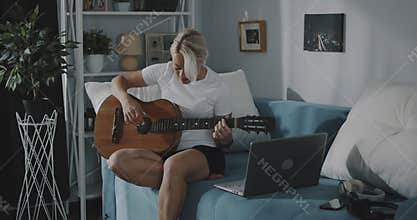 Woman learning to play the guitar