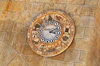 Old clock face shows time signs zodiac on western wall city Jerusalem