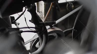 Timing belt alternator belt in motion on a running car engine