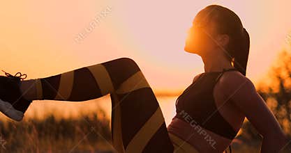 Fit healthy woman stretching on yoga mat on beach seaside,doing exercise abdominal crunches,training and lifestyle. Sit