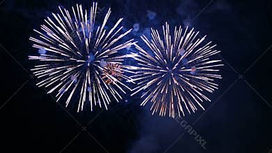 Purple fire flashes of festive fireworks in the night sky