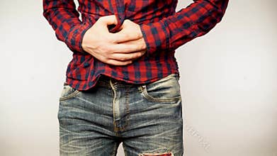 Young handsome man over isolated background with hand on stomach because nausea, painful disease feeling unwell. Ache