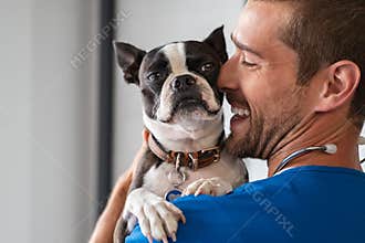 Vet cuddling pet dog