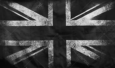 a monochrome full frame image of an old stained dirty union jack british flag with dark crumpled edges