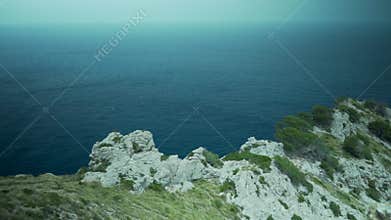 Palma de Mallorca, Spain,beautiful cliffs, high-up view, rocks and many plants and trees, sea in the background, Spanish flora