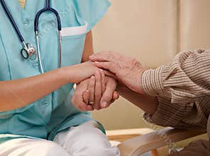 Hands of nurse and elderly patient.