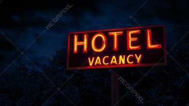 Hotel Vacancy Sign With Trees Behind At Night