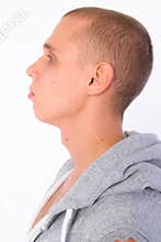 Closeup profile view of young bald rebellious man