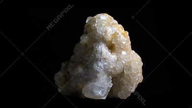 Macro shot of white crystal mineral, close-up shot with rotation. Isolated on black backround.