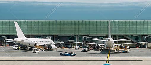 Airplanes on busy airport. Panorama