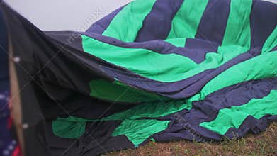 Inflating, unpack and flying up hot air balloon watermelon. Burner directing flame into envelope. Take off aircraft fly