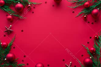 Merry Christmas red background decorated with new year tree baubles flat lay