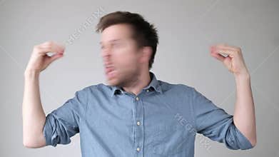 Young stressed man talking to his hands, suffering mental bipolar disorder.