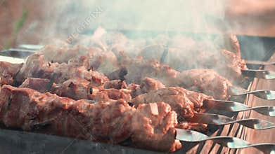 Closeup pork shashlik kebabs grilling on brazier. Tasty pork kebabs on grill