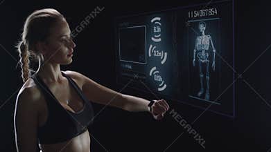 Portrait of fitness woman checking pulse with smart watch after workout.