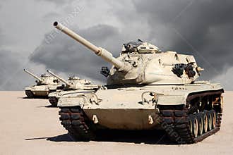 Three Army War Tanks in Desert