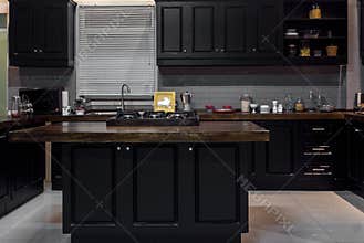 Black wood kitchen with touches of white brick