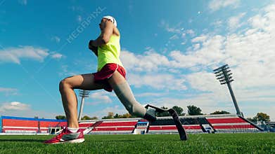 Male athlete with a prosthetic leg is stretching