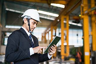 Businessman check stock in factory by tablet