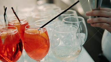 Professional bartender prepares cocktails at the bar. Mixing ingredients for a cocktail. barman preparing cocktail through filter.