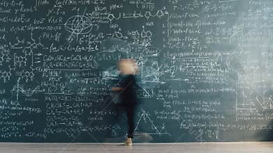 Time lapse back view of smart lady scientist writing formulas on chalkboard