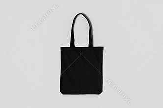 Black tote bag mockup on a grey background