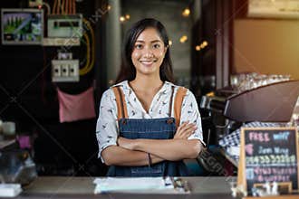 Asian women Barista smiling and using coffee machine in coffee shop counter - Working woman small business owner food and drink