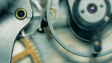 Close up of metal cogs moving in a watch mechanism