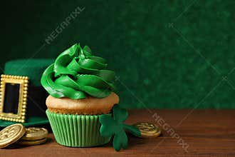 Composition with delicious decorated cupcake on table. St. Patrick`s Day celebration