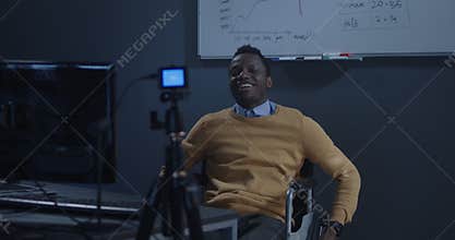 Man in wheelchair recording a video for vlog