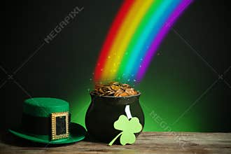 Pot with gold coins, hat and clover on table against dark background, space for text. St. Patrick`s Day