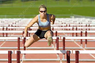 Athlete Jumping over Hurdles