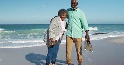 Front view old couple standing together at the beach
