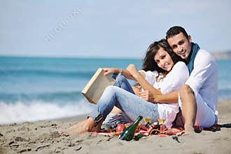 Young couple enjoying picnic on the beach