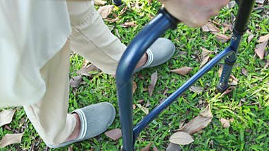 Senior asian female patient trying to walk use walking aid during rehabilitation, elderly woman walking alone with walker for safe