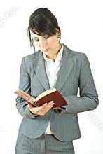 Business woman reading diary