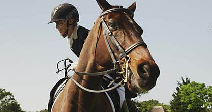 Caucasian woman riding her dressage horse