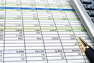 Financial forms with pen and calculator.