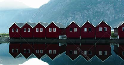 Yacht club in Sunndalsora in Norway on the banks of the Tingvollfjorden fjord with typical red boathouses.