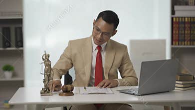 Male judge in courtroom on wooden table and male counselor or lawyer working in office Law,