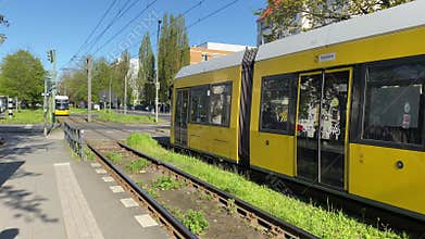 Yellow tram arriving at station in Berlin Germany