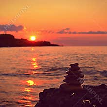 Beautiful colourful sunset on the beach with the sea and waves. A concept for travel, holidays and summer holidays by the sea.