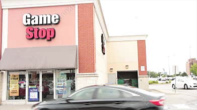 tor, canada - august 18, 2023: game stop store storefront entrance with logo on beige building writing caption 4 v