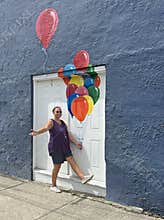 senior adult woman holding balloons