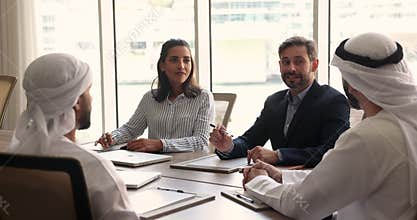Multicultural businesspeople engaged in formal negotiations in board room